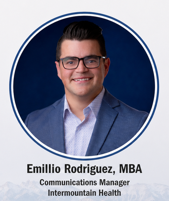 Professional headshot of a smiling man wearing glasses and a blue blazer against a dark blue background; Communications Manager, Intermountain Health.